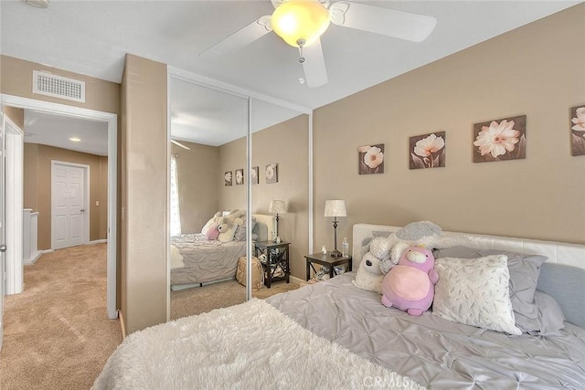 bedroom featuring carpet floors, a closet, ceiling fan, and baseboards