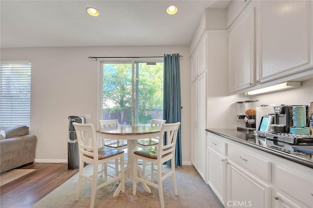 dining area featuring baseboards, light wood finished floors, and recessed lighting