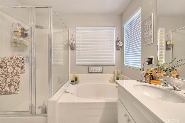 full bath featuring a stall shower, a bath, vanity, and healthy amount of natural light