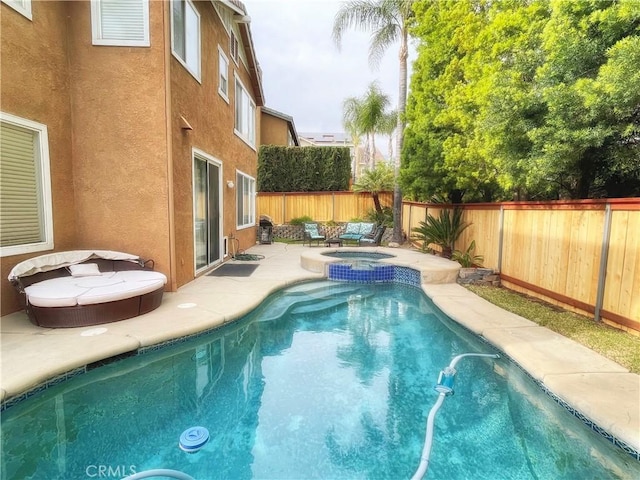 view of pool featuring a fenced backyard, a patio area, and a pool with connected hot tub