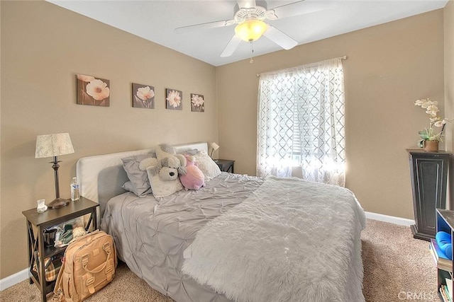 carpeted bedroom with baseboards and ceiling fan