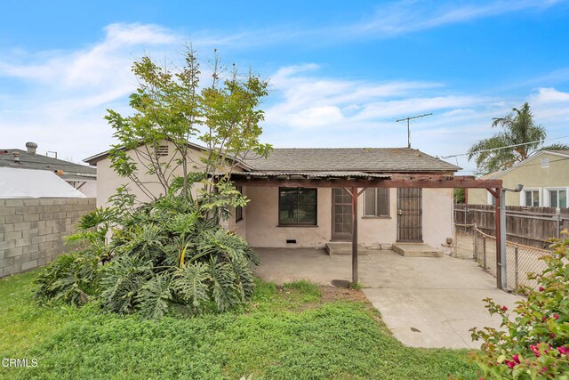 back of property featuring stucco siding, a patio, and a fenced backyard