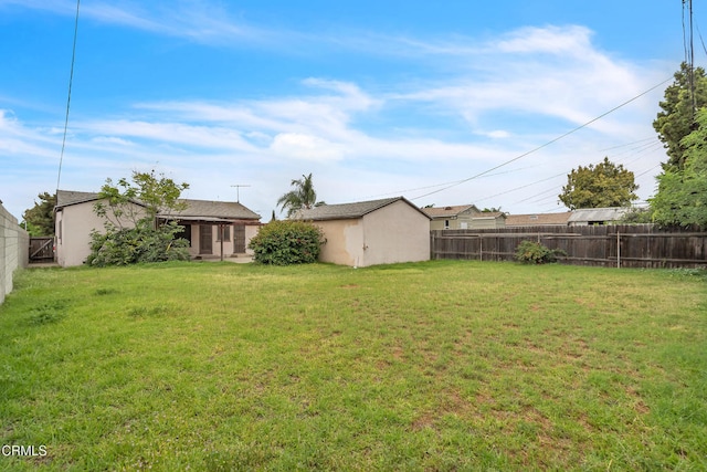 view of yard featuring a fenced backyard and an outdoor structure