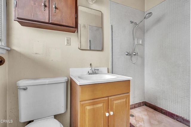 full bathroom with vanity, toilet, and tiled shower