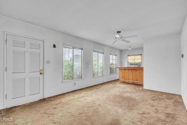 interior space featuring carpet floors, a ceiling fan, and cooling unit