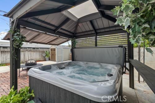 1230 Kilson Dr, Santa Ana, CA 92707 - view of patio / terrace with a hot tub, a gazebo, and a storage unit