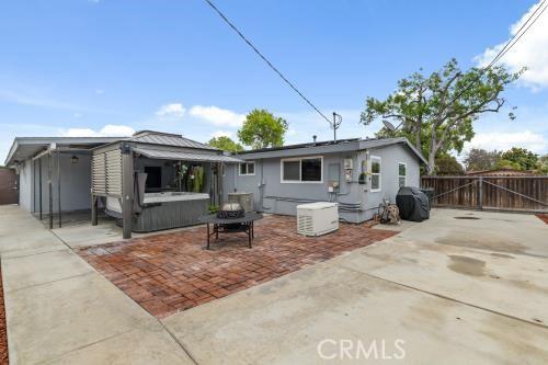1230 Kilson Dr, Santa Ana, CA 92707 - back of property with a hot tub, a patio area, and a gate