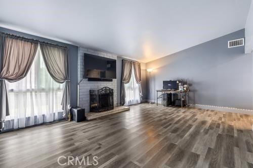 1230 Kilson Dr, Santa Ana, CA 92707 - living room featuring wood finished floors, plenty of natural light, and a brick fireplace