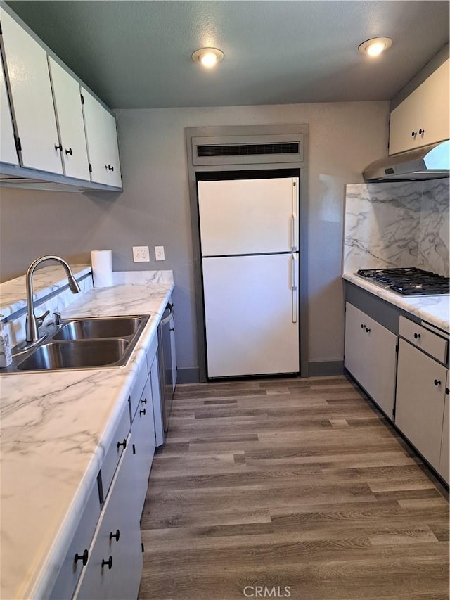 1230 Kilson Dr, Santa Ana, CA 92707 - kitchen featuring stainless steel appliances, light countertops, white cabinets, wood finished floors, and under cabinet range hood