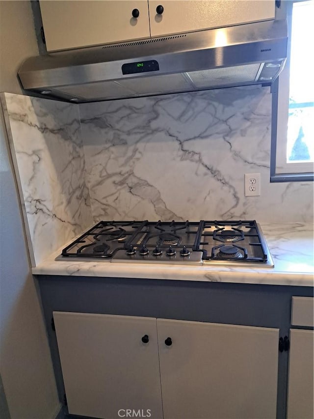 1230 Kilson Dr, Santa Ana, CA 92707 - kitchen featuring under cabinet range hood, decorative backsplash, light countertops, and stainless steel gas cooktop