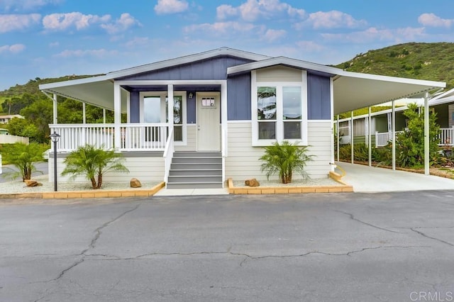 manufactured / mobile home with an attached carport and covered porch