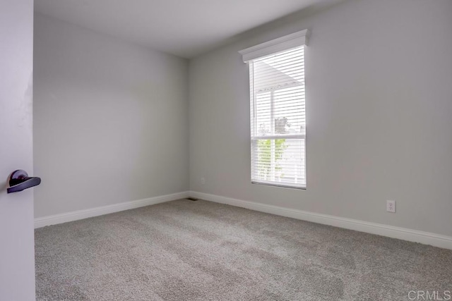 spare room with carpet flooring and baseboards