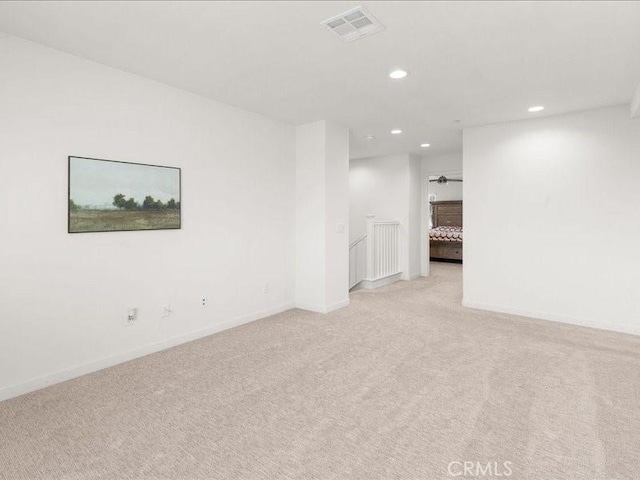 spare room featuring recessed lighting, baseboards, visible vents, and light colored carpet