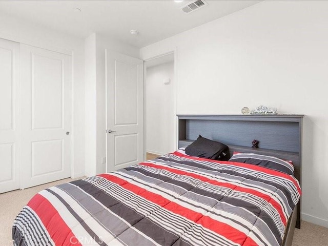 bedroom featuring carpet floors, visible vents, and baseboards