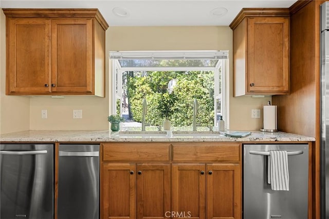 693 Old Meadow Pl, Lake Arrowhead, CA 92352 - kitchen with light stone countertops, stainless steel dishwasher, a sink, and brown cabinets