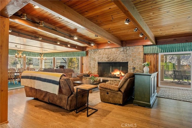 693 Old Meadow Pl, Lake Arrowhead, CA 92352 - bedroom with wood-type flooring, a fireplace, beam ceiling, and multiple windows