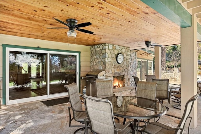 693 Old Meadow Pl, Lake Arrowhead, CA 92352 - view of patio / terrace featuring outdoor dining area, a stone fireplace, ceiling fan, and area for grilling