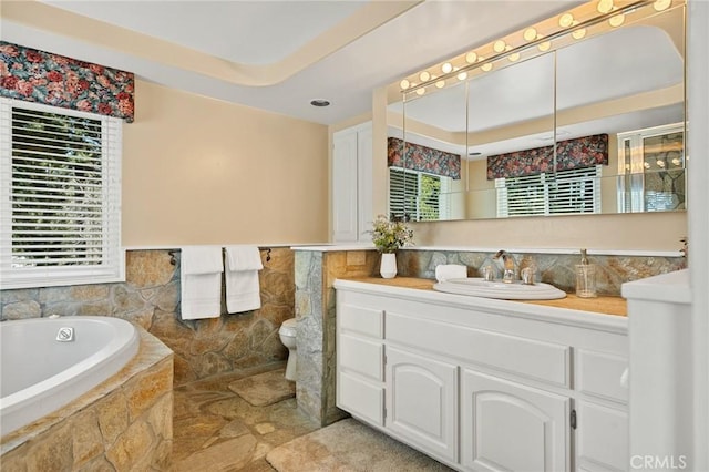 693 Old Meadow Pl, Lake Arrowhead, CA 92352 - full bathroom featuring a raised ceiling, toilet, vanity, tile walls, and a garden tub