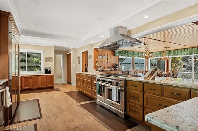 693 Old Meadow Pl, Lake Arrowhead, CA 92352 - kitchen featuring brown cabinets, island exhaust hood, light stone counters, light wood-type flooring, and high quality appliances
