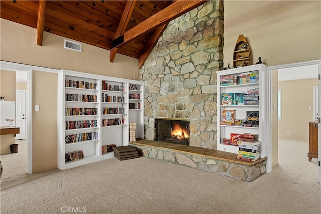 693 Old Meadow Pl, Lake Arrowhead, CA 92352 - carpeted living area with vaulted ceiling with beams, wooden ceiling, visible vents, and a stone fireplace