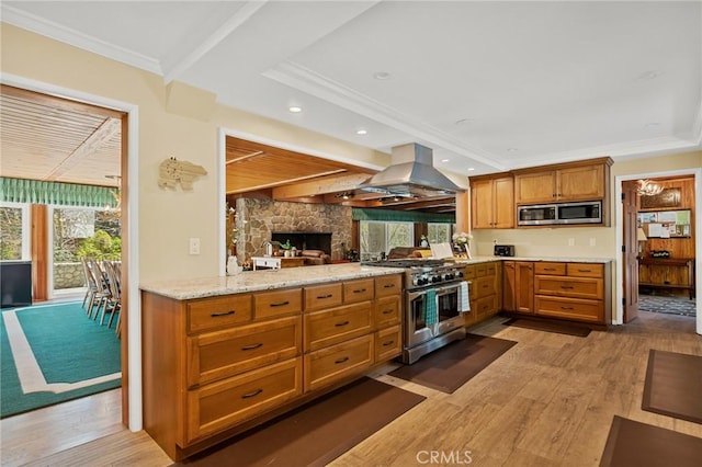 693 Old Meadow Pl, Lake Arrowhead, CA 92352 - kitchen with island range hood, a wealth of natural light, stainless steel appliances, and light wood finished floors