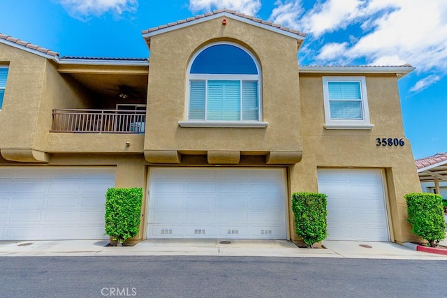 35806 Springvale Ln Unit 2, Murrieta, CA 92562 - view of property featuring stucco siding, a balcony, and an attached garage
