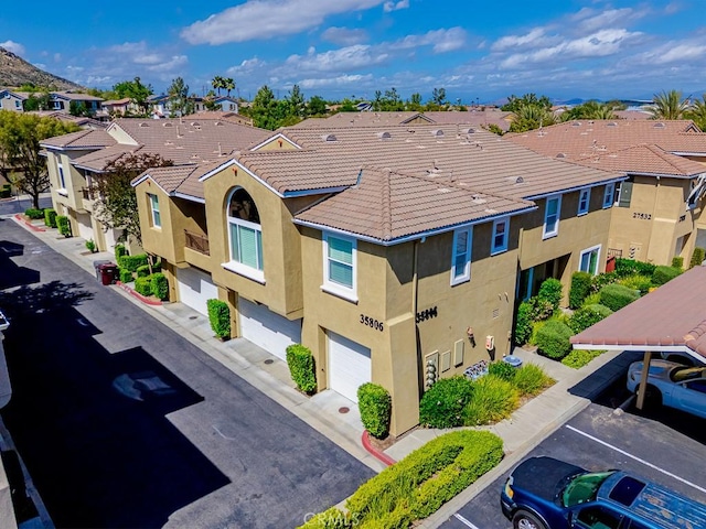35806 Springvale Ln Unit 2, Murrieta, CA 92562 - view of building exterior with a residential view, a garage, and uncovered parking