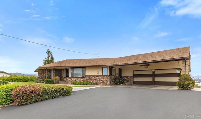 1170 Avocado Ave, Escondido, CA 92026 - single story home with stucco siding, aphalt driveway, stone siding, and a garage