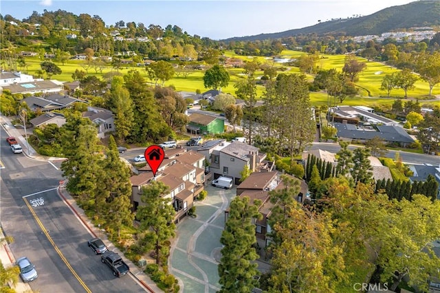 aerial view with a residential view, a mountain view, and view of golf course