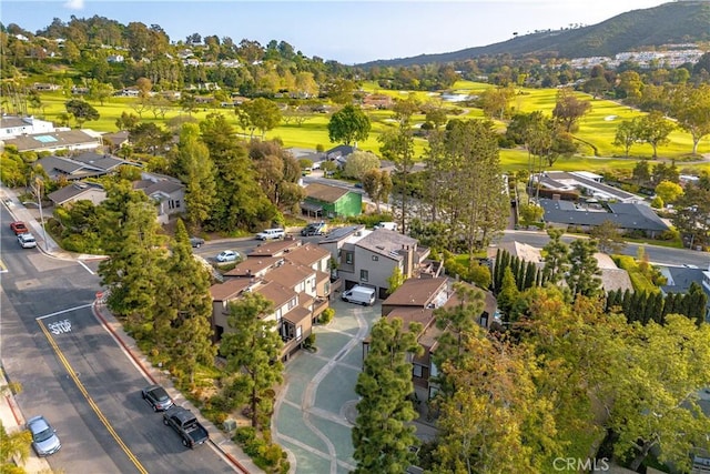 aerial view with a residential view, a mountain view, and view of golf course
