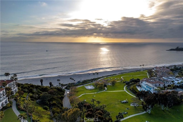 birds eye view of property with a view of the beach and a water view