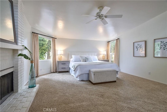 bedroom with carpet, a ceiling fan, and a brick fireplace