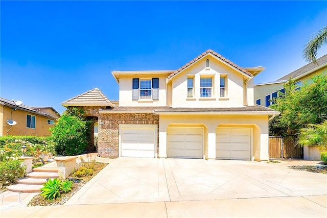 1961 W Snead St, La Habra, CA 90631 - traditional-style house with an attached garage, stucco siding, a tiled roof, concrete driveway, and brick siding