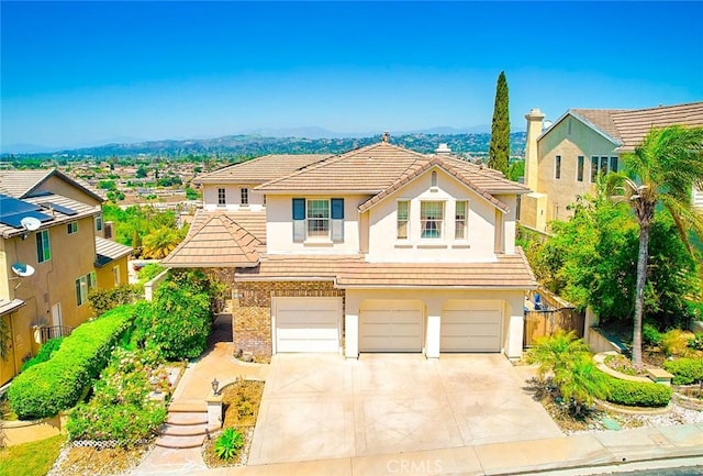 1961 W Snead St, La Habra, CA 90631 - traditional home with a garage, driveway, a tiled roof, and stucco siding