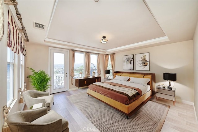 1961 W Snead St, La Habra, CA 90631 - bedroom featuring a tray ceiling, access to outside, light wood-type flooring, and baseboards