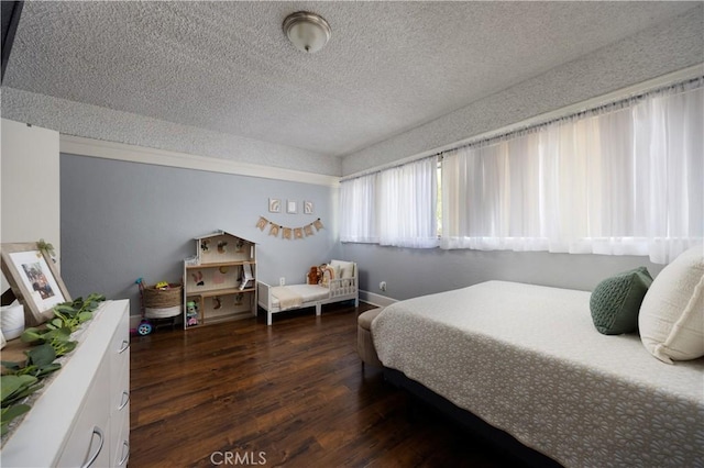 bedroom featuring wood-type flooring and a textured ceiling
