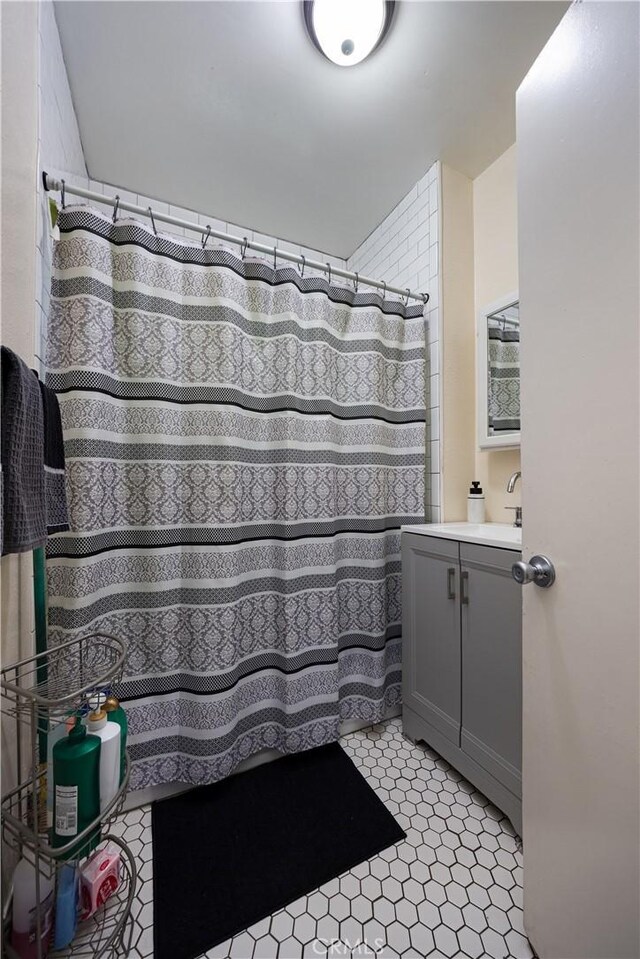 bathroom featuring vanity and a shower with shower curtain