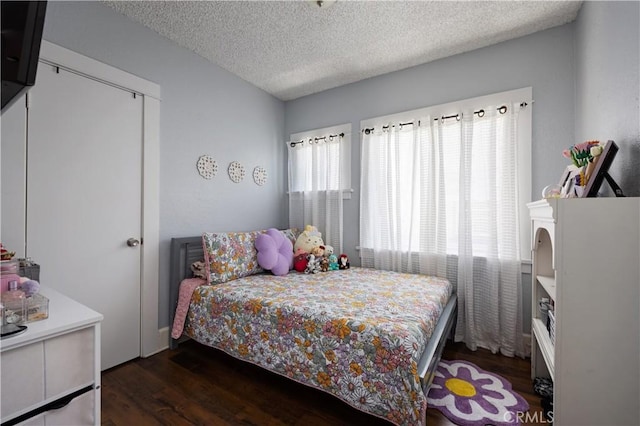 bedroom featuring wood finished floors and a textured ceiling