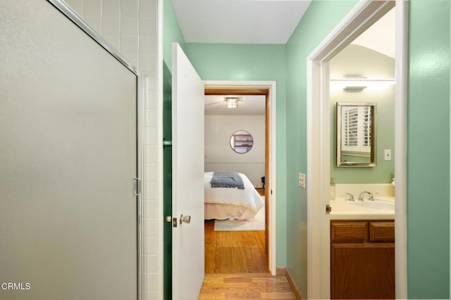 bathroom with ensuite bath, an enclosed shower, vanity, and wood finished floors