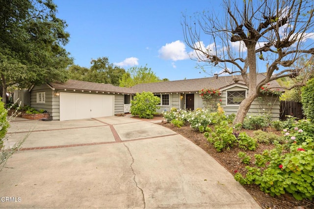 ranch-style home with concrete driveway and a garage