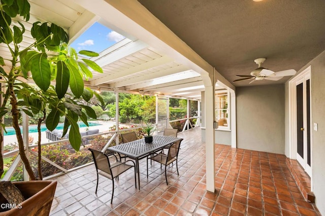 view of patio / terrace with an outdoor pool and a ceiling fan