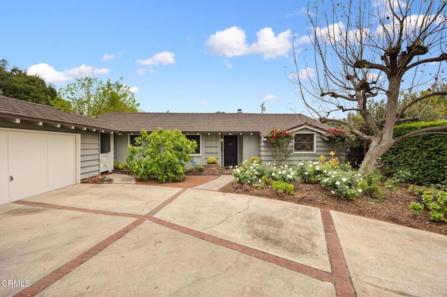 ranch-style house featuring an attached garage and driveway