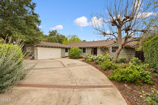 single story home with a garage and driveway