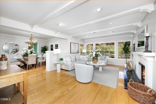 living area with recessed lighting, an inviting chandelier, light wood-style floors, beam ceiling, and a fireplace