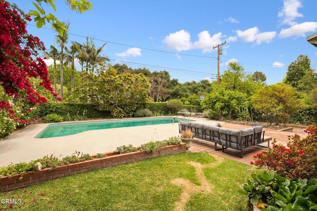 view of pool featuring a patio area, a fenced in pool, and a lawn