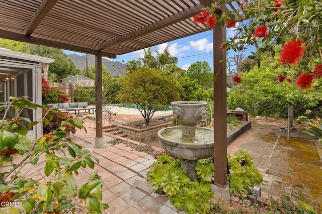 view of patio / terrace with a pergola, outdoor lounge area, fence, and a mountain view