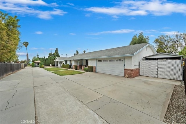 4423 N Sunflower Ave, Covina, CA 91724 - view of front of house with brick siding, fence, driveway, and a garage