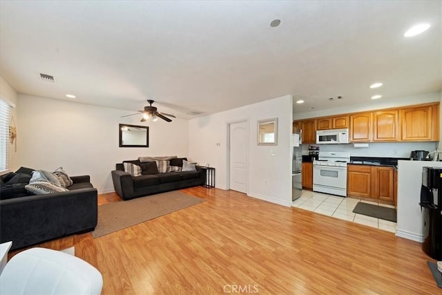 4423 N Sunflower Ave, Covina, CA 91724 - living room featuring recessed lighting, light wood-type flooring, a ceiling fan, and baseboards