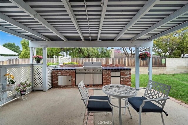 4423 N Sunflower Ave, Covina, CA 91724 - view of patio / terrace featuring exterior kitchen, outdoor dining area, and a fenced backyard