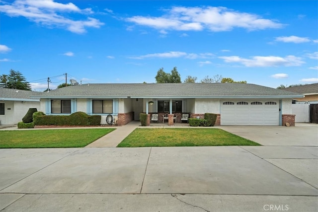 4423 N Sunflower Ave, Covina, CA 91724 - ranch-style house featuring a front lawn, concrete driveway, a garage, brick siding, and stucco siding